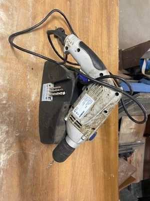 an image of a corded drill on a wooden table