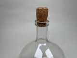 a glass bottle with a cork stopper inside of it