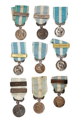 an assortment of medals and medals are displayed on a white surface