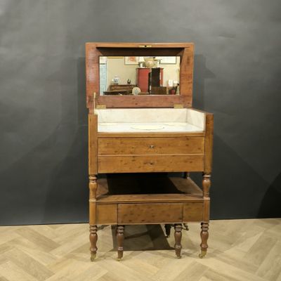 a wooden dresser with a mirror on top of it
