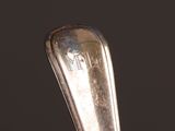 a silver spoon with the word nth on it