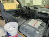 dashboard of a car with a bucket of paint and a bucket of paint
