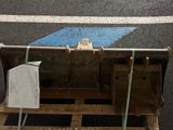 a pallet with a piece of wood on it on the street