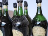 several bottles of wine are lined up on a table
