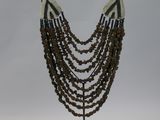 beaded necklace on a stand on a white background
