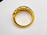 an image of a gold ring sitting on top of a white surface