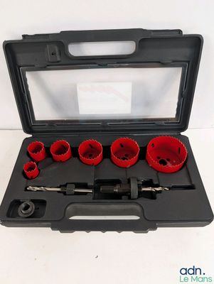 a set of red holesaws in a black case on a white surface