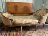 a chaise lounger in a room with a rug on the floor