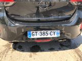 the back of a black car with a license plate on it ' s bumper