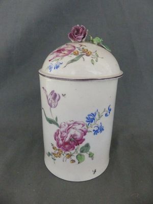 a white container with flowers on it on a table