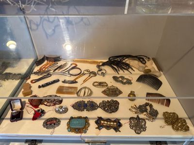 a glass display case with a lot of jewelry on it