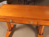a small wooden table with two drawers on it