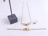 three pieces of jewelry sitting on top of a table next to each other