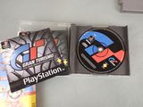 two dvds on a table with a game in the background