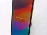 a close up of a phone on a stand with the word bonjou written on it