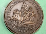a bronze coin with a picture of a horse and rider on it