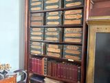 a book shelf with many books on it in a room