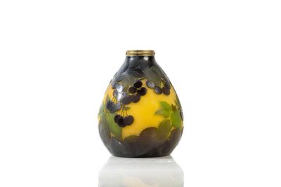 yellow and black vase sitting on top of a white surface