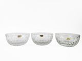 three clear glass bowls sitting on top of a white surface