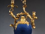 pair of blue and gold vases with flowers on each of them