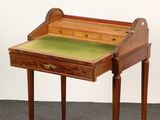 a wooden desk with a green top and a drawer