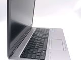 a silver laptop with a black keyboard on a white surface