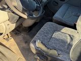 the interior of a car with a dirty seat and steering wheel