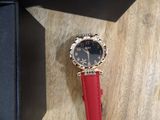 wrist watch with red leather strap and black face