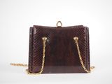 an image of a brown snake skin purse with gold chains