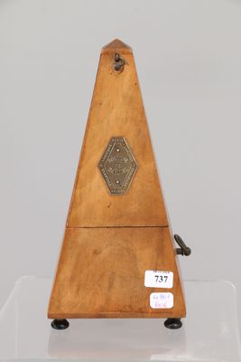 a small wooden instrument on display on a clear surface