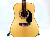 a guitar that is sitting on a stand on a white background