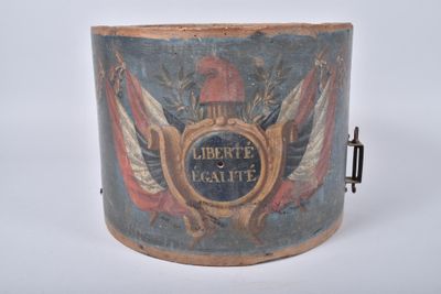 an old wooden bucket with a painting of a coat of arms and a shield on it