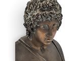 bust of a young man with curly hair and a collared shirt