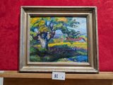 une peinture à l'huile représentant un arbre, posée sur une étagère devant un mur rouge