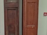 two tall wooden clocks next to each other in a room