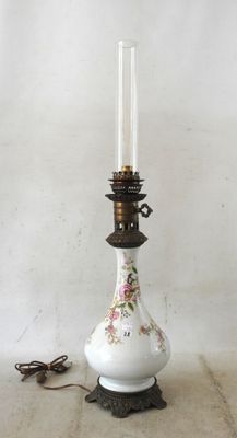a white vase with a floral design on it next to a pair of scissors