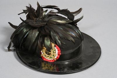 a black hat with a gold crown on top of it