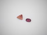 a pair of pink tourmaline gems on a white surface