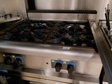 a stainless steel stove and oven in a commercial kitchen