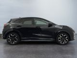 a black honda hrx parked in a room with a gray background