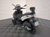 a motor scooter that is parked in a room