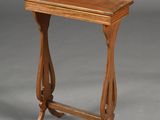 an old wooden table with a wooden top on a gray background
