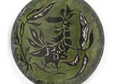 a green plate with black and white designs on it