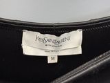 the label of a black leather bag with a white label on it