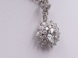 an image of a diamond pendant on a chain on a white surface