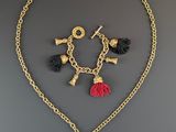 a necklace and earring set with tassels on a chain