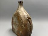 a brown vase that is sitting on a table