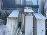a lot of junk in front of a building with a lot of windows