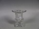 a clear glass vase with a clear base on a white surface