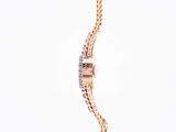 an image of a woman ' s wrist watch with a chain around it